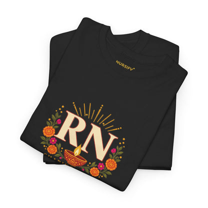 Folded black RN Diwali T shirt showing the ivory RN, diya and floral print, with a gold Nursify inside neck label.