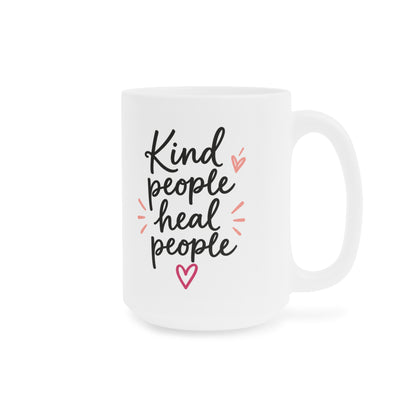 White 15oz ceramic mug with Kind People Heal People handwritten lettering and pink heart, handle on right.