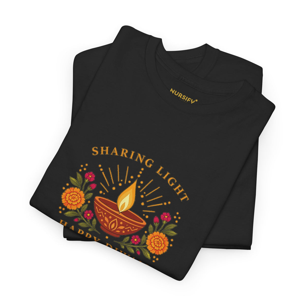 Folded black Happy Diwali T shirt showing the Sharing Light diya and floral print, with a gold Nursify inside neck logo.