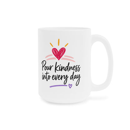 White 15oz ceramic mug with Pour Kindness Into Every Day lettering, raspberry heart and golden rays, handle on right.