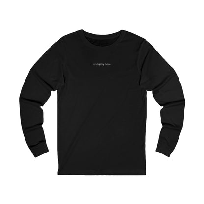 Front view of a Black Nursify Emergency Nurse script long sleeve shirt, showing the centred chest lettering.