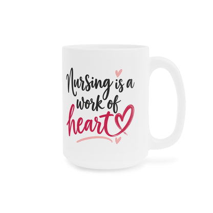 White 15oz ceramic mug with Nursing Is a Work of Heart lettering and raspberry heart, handle on right.