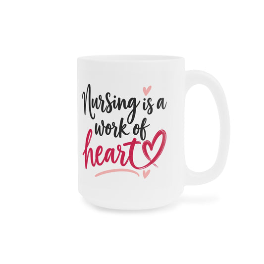 White 15oz ceramic mug with Nursing Is a Work of Heart lettering and raspberry heart, handle on right.