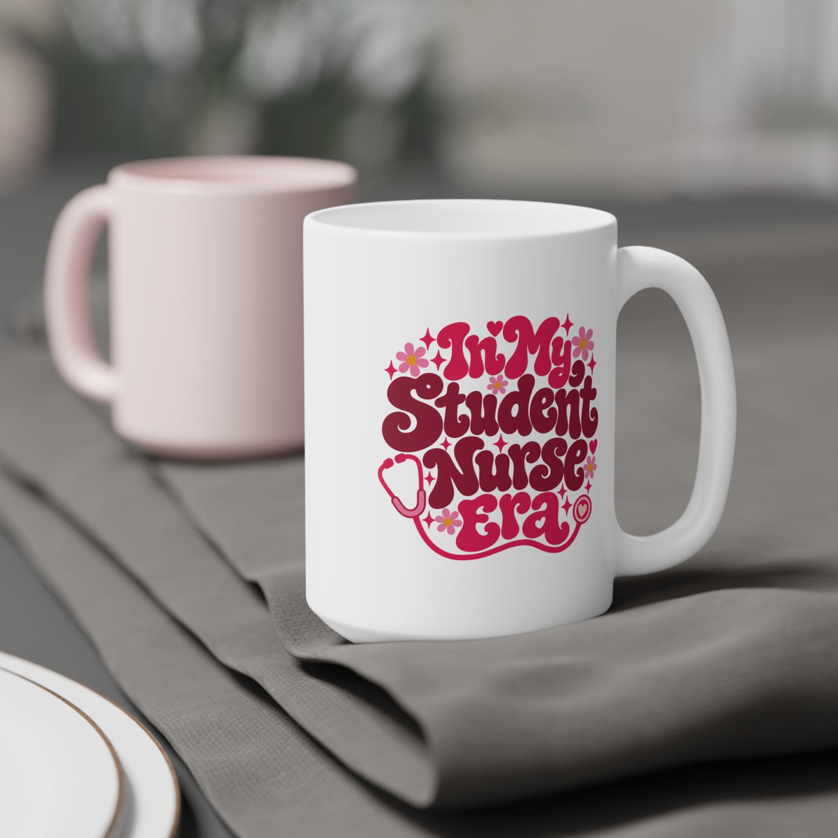 In My Student Nurse Era Mug, Pink Floral, 15 oz, styled supplier scene with centred artwork