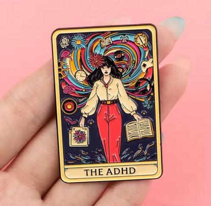 ADHD tarot enamel pin held in hand showing colorful neurodivergent mental health design. 