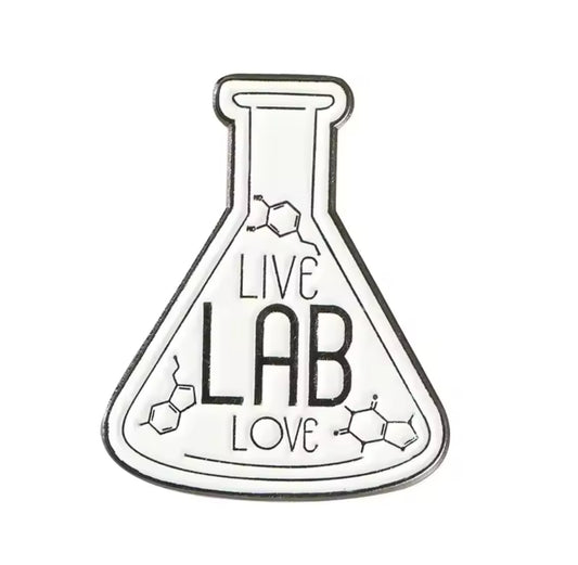 Flask-shaped enamel pin with the words ‘LIVE LAB LOVE’ and molecular structure accents in black and white.