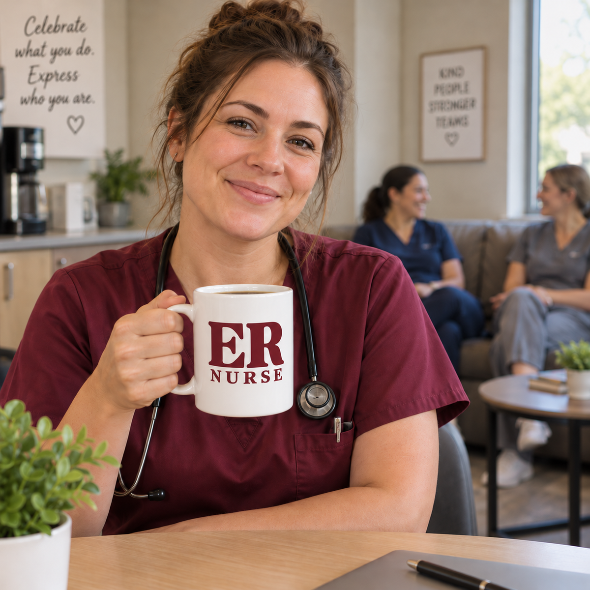 Nurse holding the burgundy ER nurse mug during a break, with two teammates chatting on a couch behind them.