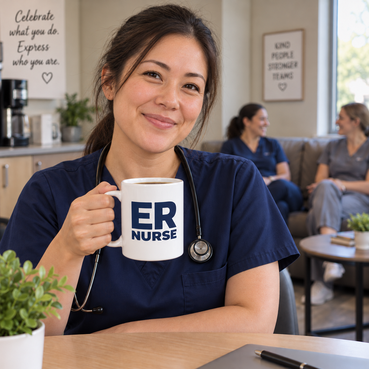 Nurse holding a navy emergency nurse mug in the staff break room, with teammates chatting on a couch behind her.