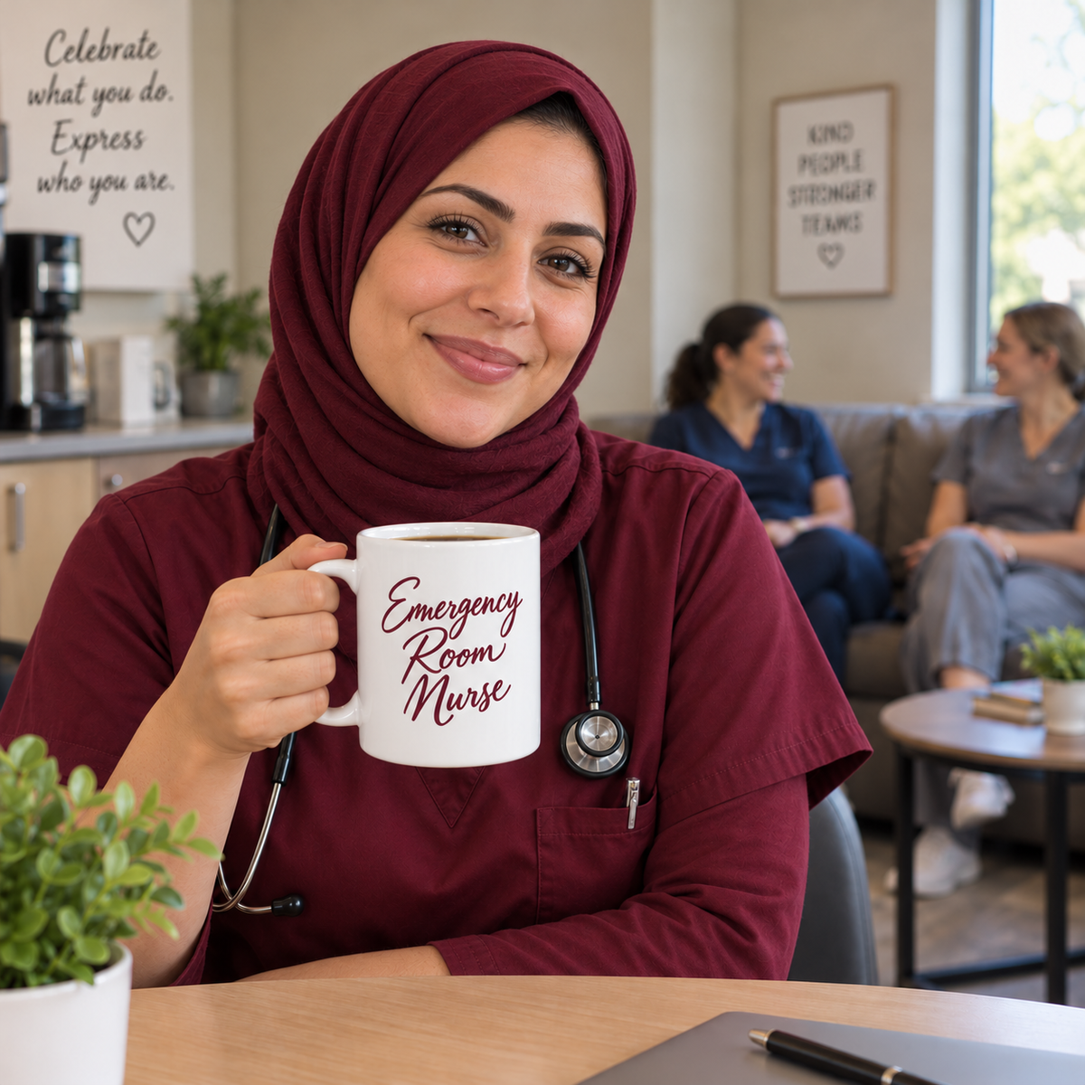 Nurse holding a burgundy emergency nurse mug in the staff break room, with teammates chatting on a couch behind her.
