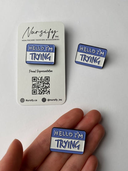 Hello I'm trying enamel pin in white and blue name tag design | size shown compared to an average-sized woman’s hand