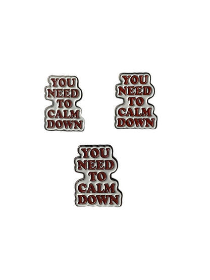 You need to calm down enamel pin in orange and white text design 