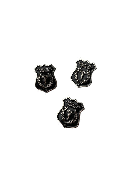 Black and silver Essential Worker enamel pin with rubber clutch backing