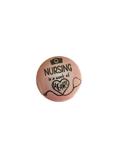 Pink Nursing Is a Work of Heart button pin with stethoscope design