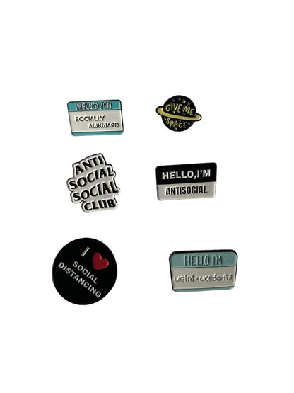 Introvert enamel pins with quotes: “Hello, I’m Socially Awkward,” “Gave Me Space,” “Antisocial Social Club,” “Hello, I’m Antisocial,” “I Love Social Distancing,” “Hello, I’m Weird Plus Wonderful” . 