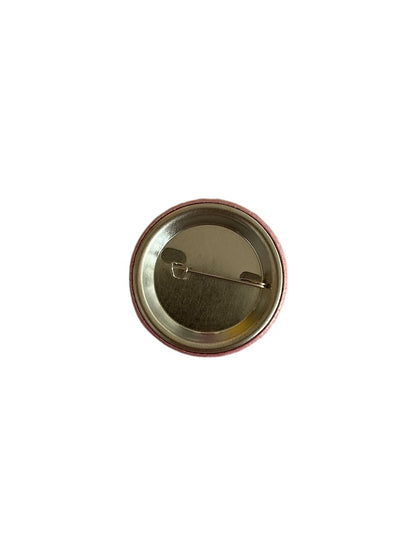 Back of pink Nursing Is a Work of Heart button showing safety-pin closure
