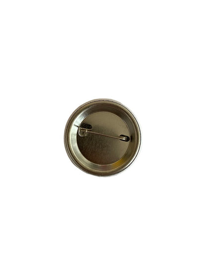 Safety-pin backing on a round Nursing Quote button