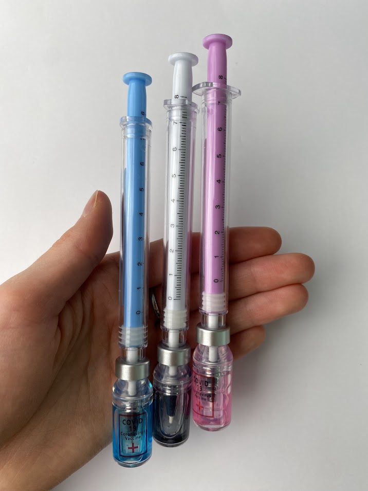 Vial and needle pen in pink, blue and black ink. shown in a had for sizing