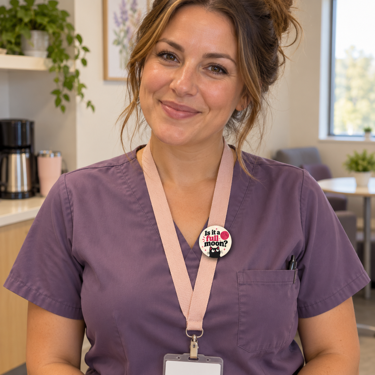 Nurse in purple scrubs wearing a Full Moon cat button on a blush lanyard