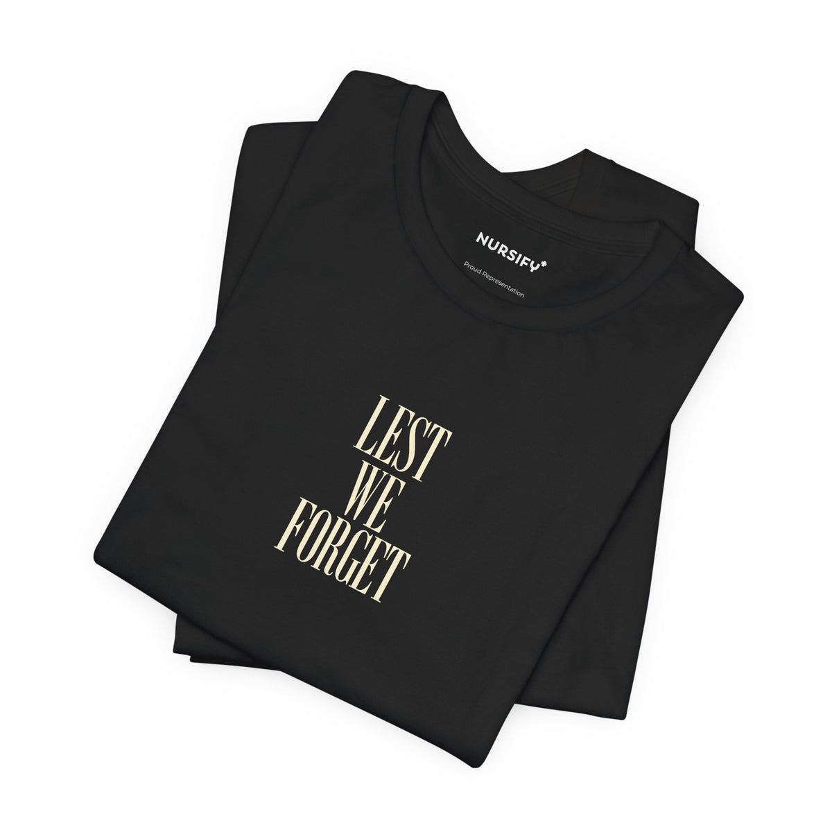 Folded black Lest We Forget shirt with centred Remembrance lettering.