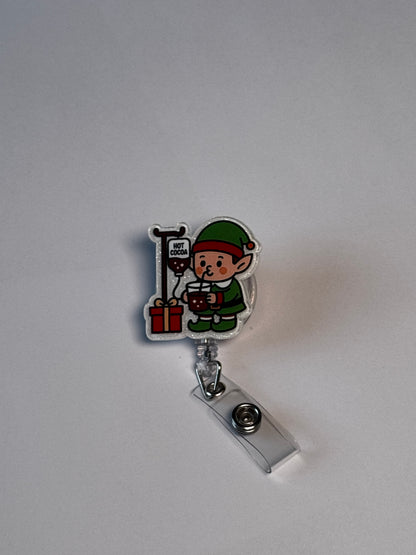 6. Elf with Cocoa IV. Actual Elf with IV Pole Christmas Badge Reel front
