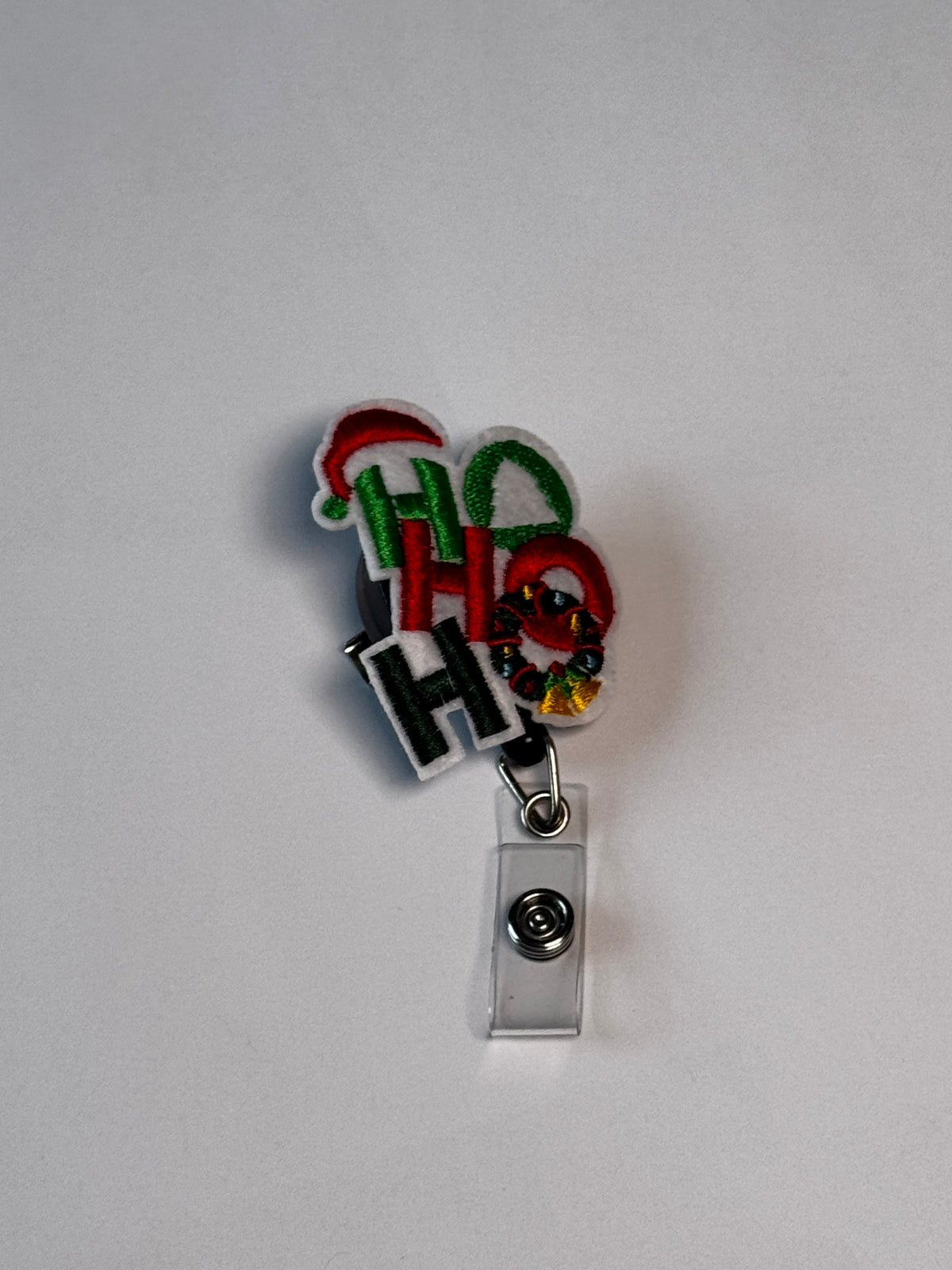 1. Ho Ho Ho. Actual Ho Ho Ho Christmas Badge Reel front