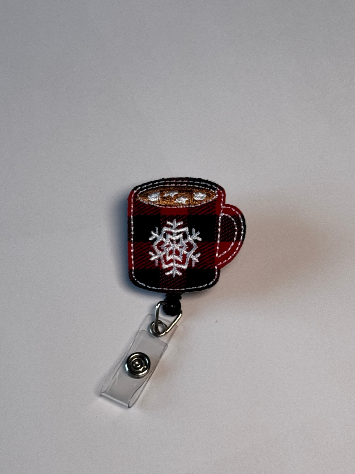 5. Plaid Cocoa Mug. Actual Plaid Mug Christmas Badge Reel front