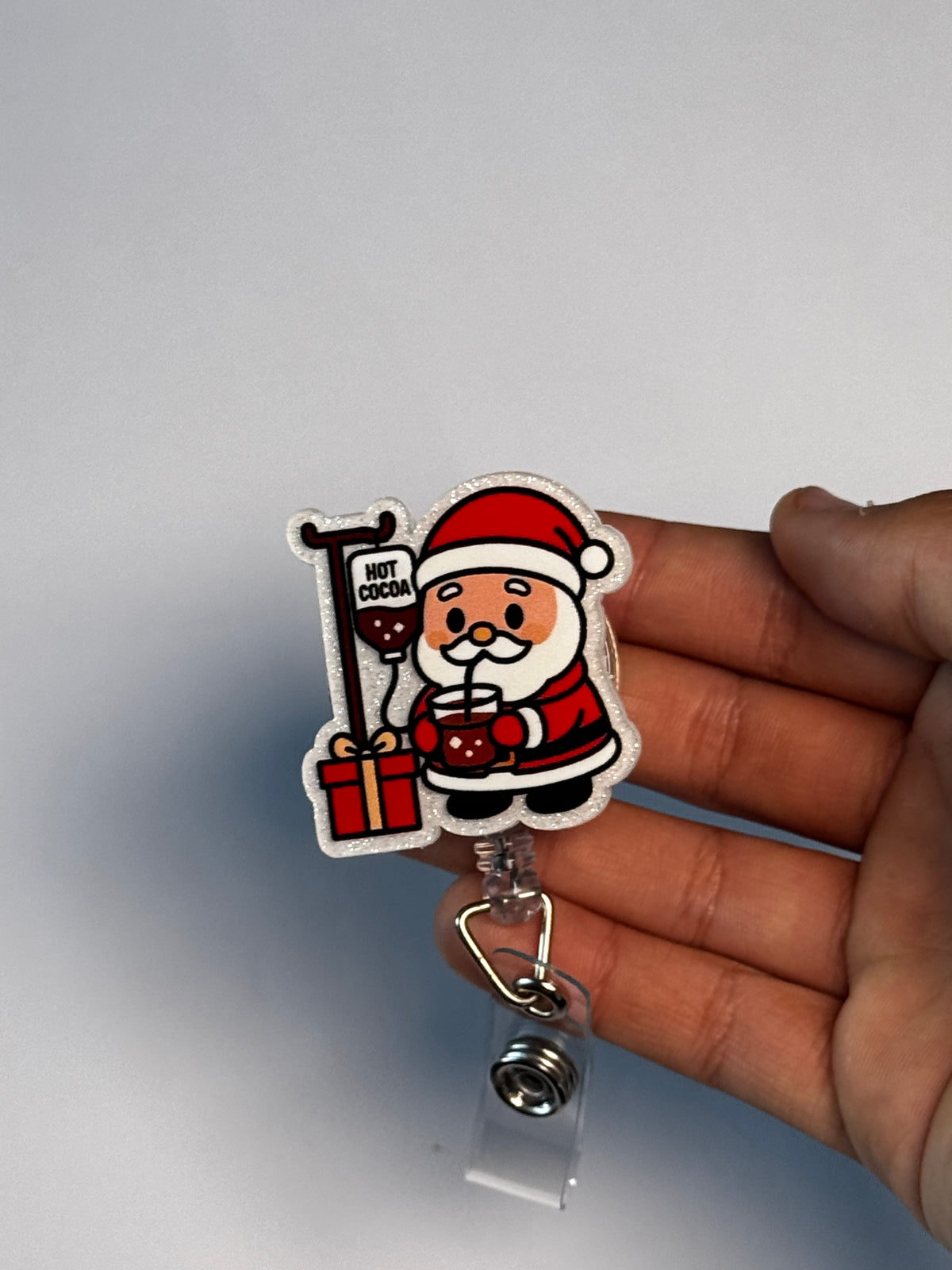 3. Santa with Cocoa IV. Actual Santa with IV Pole Christmas Badge Reel held in hand; hand shown for visual reference only