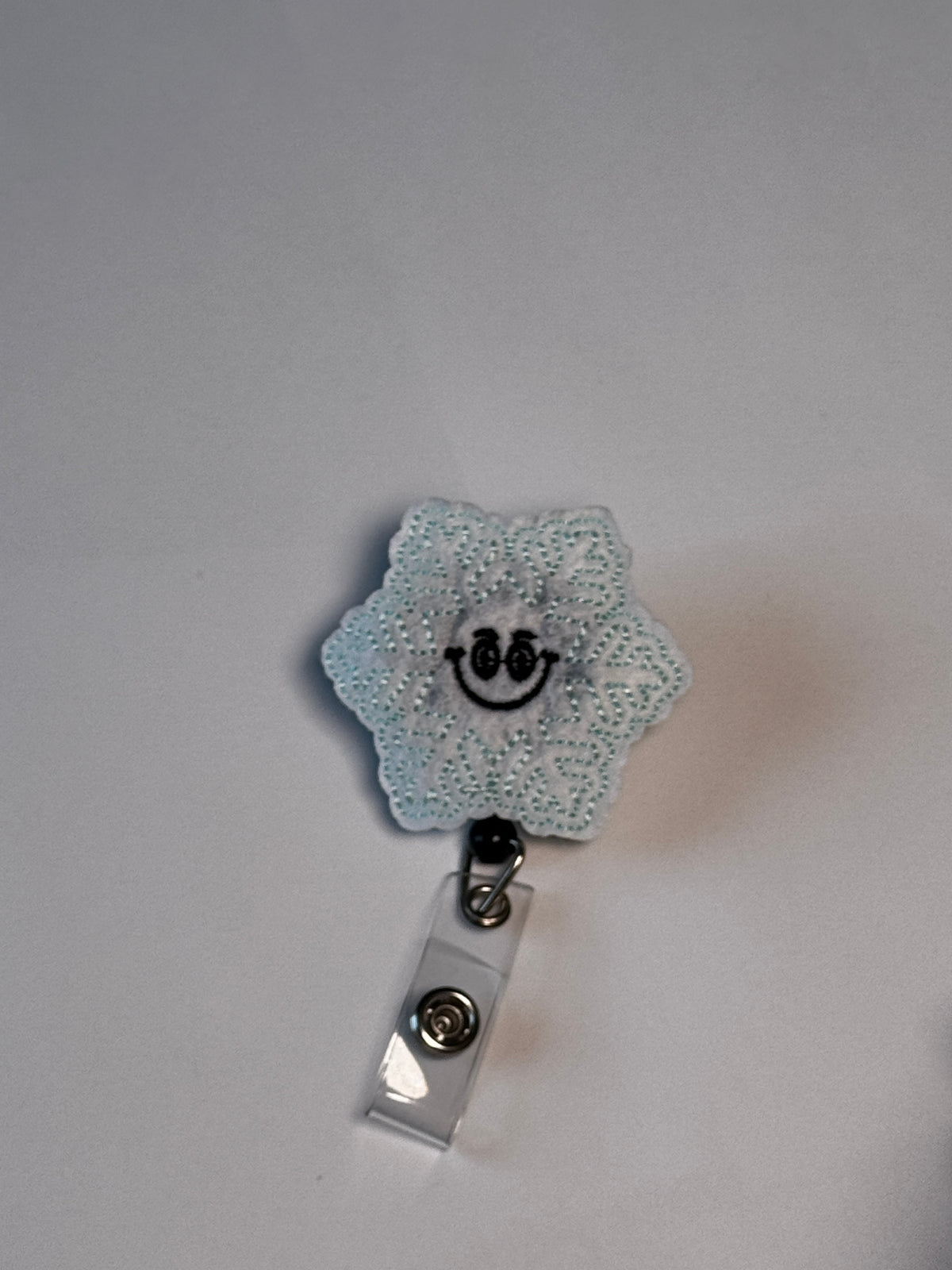 9. Smiling Snowflake. Actual Smiling Snowflake Badge Reel front