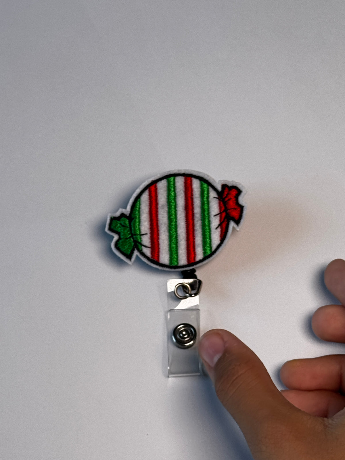 8. Striped Candy. Actual Striped Candy Christmas Badge Reel front